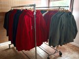 a lot of shirts hanging on a rack in a store