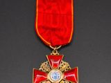 a close up of a medal with a red ribbon around it
