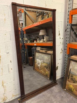 two mirrors that are sitting on a shelf next to each other