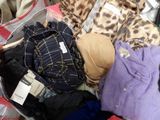a suitcase full of clothes and clothes that are in it