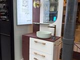a bathroom with a sink and a mirror in the window