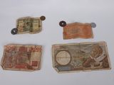 several different types of currency are laid out on a white surface