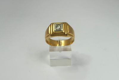 a close up of a gold ring with a diamond on it