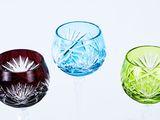 several different colored wine glasses sitting on top of each other