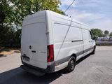 the back of a white van is parked in a parking lot