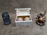 three figurines sitting next to each other on a table