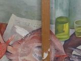 a painting of a fish on a table next to a glass