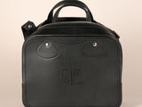 a black leather bag with a monogram logo on the front