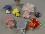 a lot of different colored crystal figurines sitting on a table