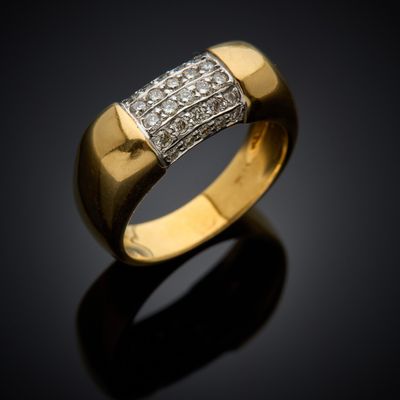 a close up of a gold and diamond ring on a black surface