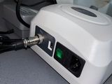 a white device that has a green light on it
