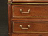 an antique wooden chest of drawers with brass hardware on top