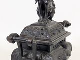 a statue of a man riding a horse on top of a box