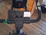 a stationary exercise bike in a room with a wooden floor
