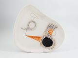 an image of a white plate with an orange and black design on it