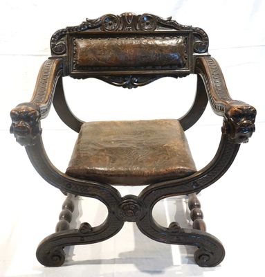 a wooden chair with a leather seat on a white background