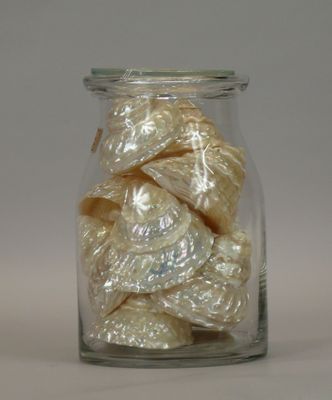 a glass jar filled with white candies on a table
