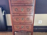 a tall wooden chest of drawers in a room