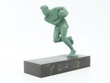 statue of a man running on a marble base