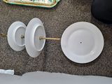 two plates and a bowl on the floor next to each other