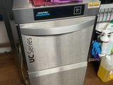 a silver dishwasher sitting in a kitchen next to a counter