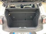 the back of a car with its trunk open and a license plate in the trunk