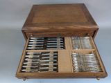 a wooden box with silverware in it on a table