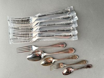 a lot of forks and spoons sitting on a table
