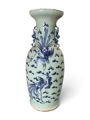 a blue and white vase sitting on a white surface