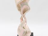 an image of a sculpture of a woman ' s face on a black base