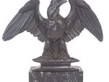 a statue of an eagle on a marble base