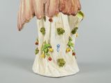 a figurine of a bird with a flower on it ' s head