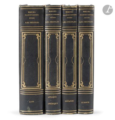 a set of four black books with gold trimmings