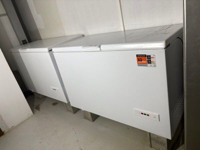 a white chest freezer sitting in the corner of a room