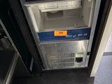 a small refrigerator that has a lot of empty glasses on top of it