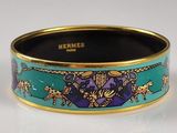 turquoise and gold bangle with a design of horses and lions on it