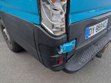 a close up of the front end of a blue van