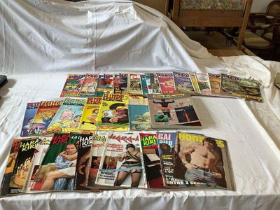 a lot of magazines on a bed with a white sheet
