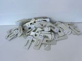 a pile of clamps on the floor next to a wall