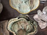 a table with a bowl of yarn and other items on it