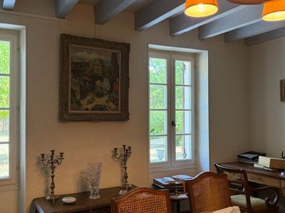 an image of a living room with a table and chairs