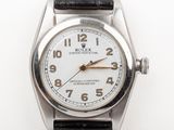 an image of a close up of a wrist watch on a white surface