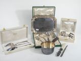 a silverware set in a case with a silver spoon and a silver cup