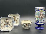 three pieces of pottery sitting on top of a table next to each other