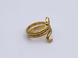 an image of a gold snake ring on a white surface