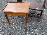 a small table and a chair sitting on the gravel