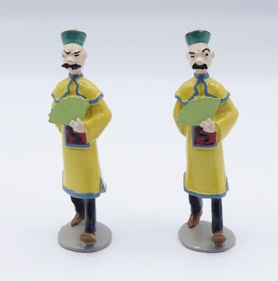 two figurines of a man and a woman holding books