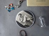 a keychain with a picture of a naked woman on it