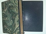 a black book with a green cover on a table
