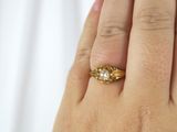 a woman ' s hand with a gold ring on it